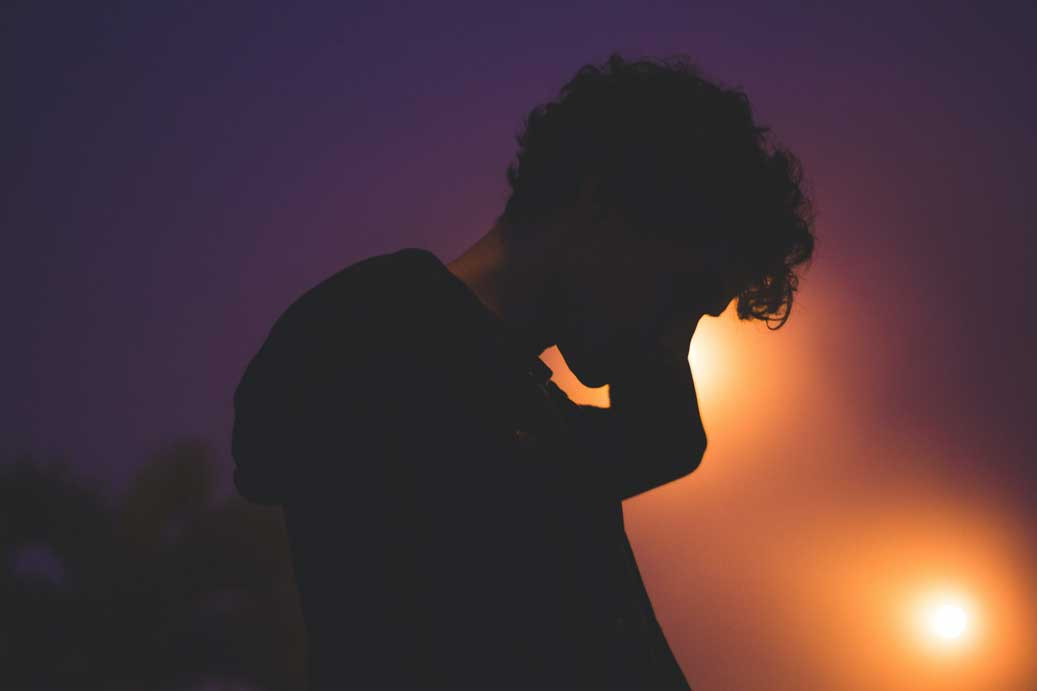 a person rubbing the back of their neck