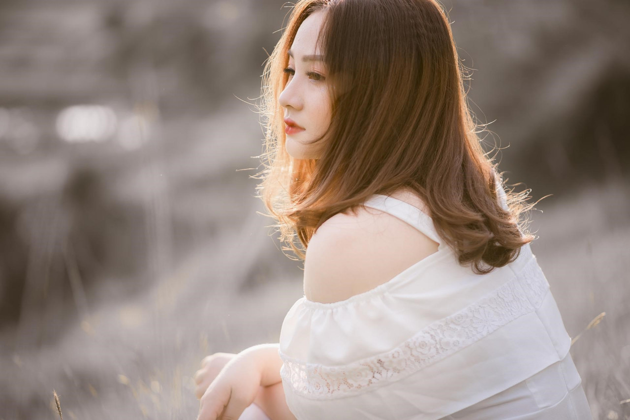 woman sitting down gazing into the distance