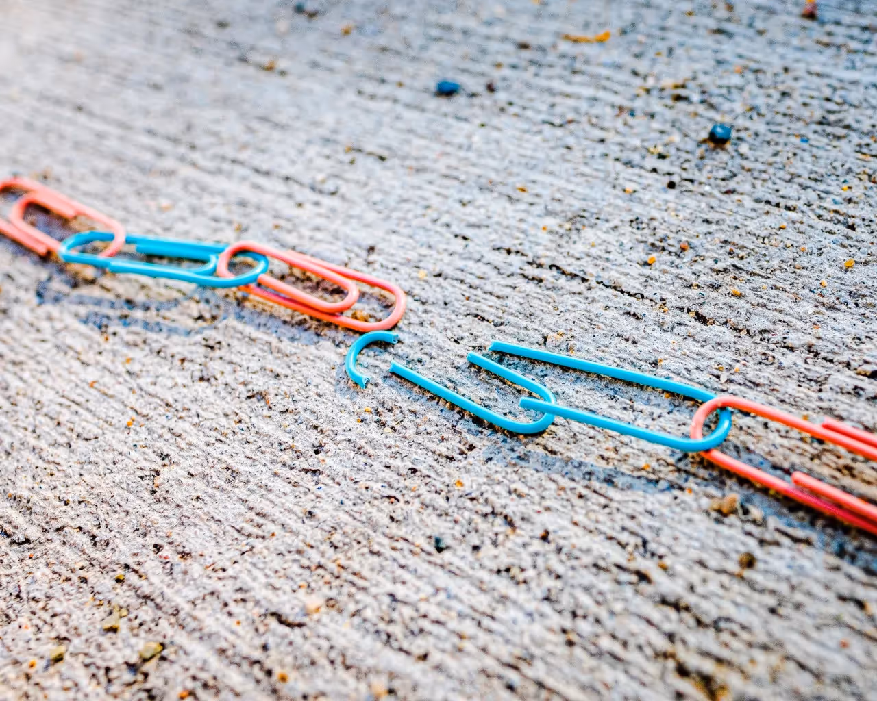 Paper clips chained together with one broken