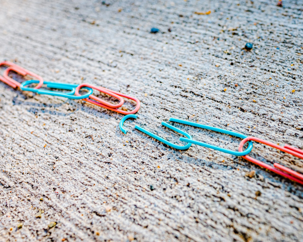Paper clips chained together with one broken