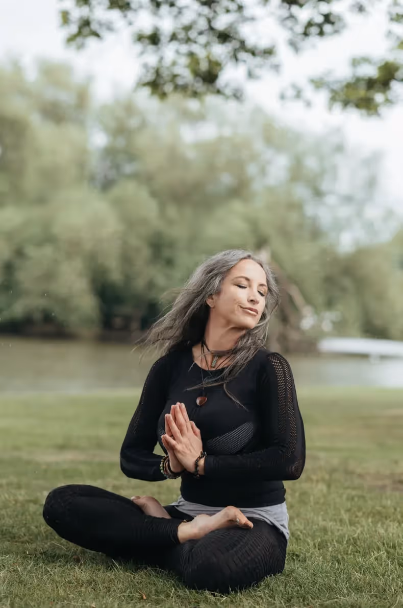 Woman sitting outside meditating