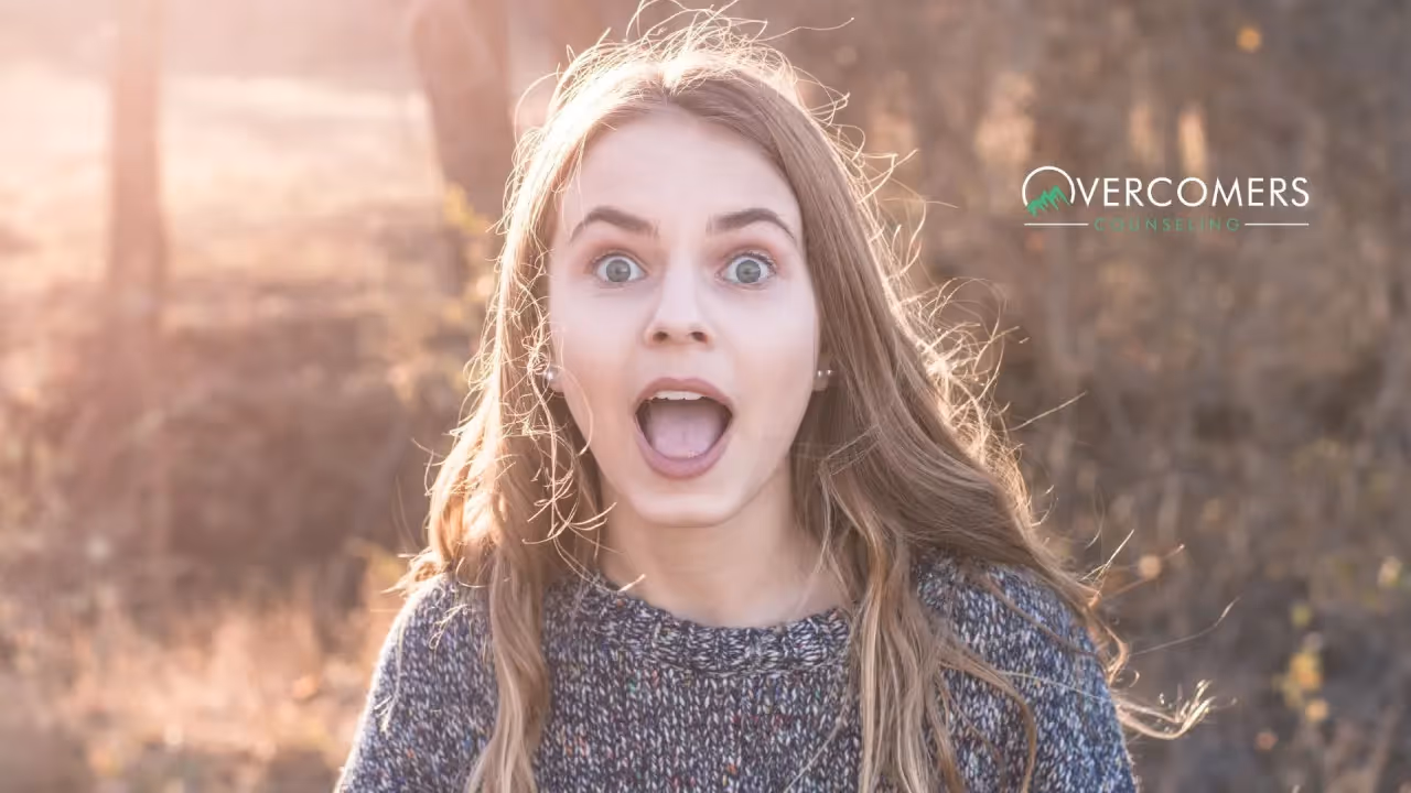 a person looking directly at the camera and looking surprised