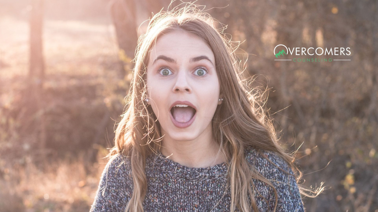 a person looking directly at the camera and looking surprised