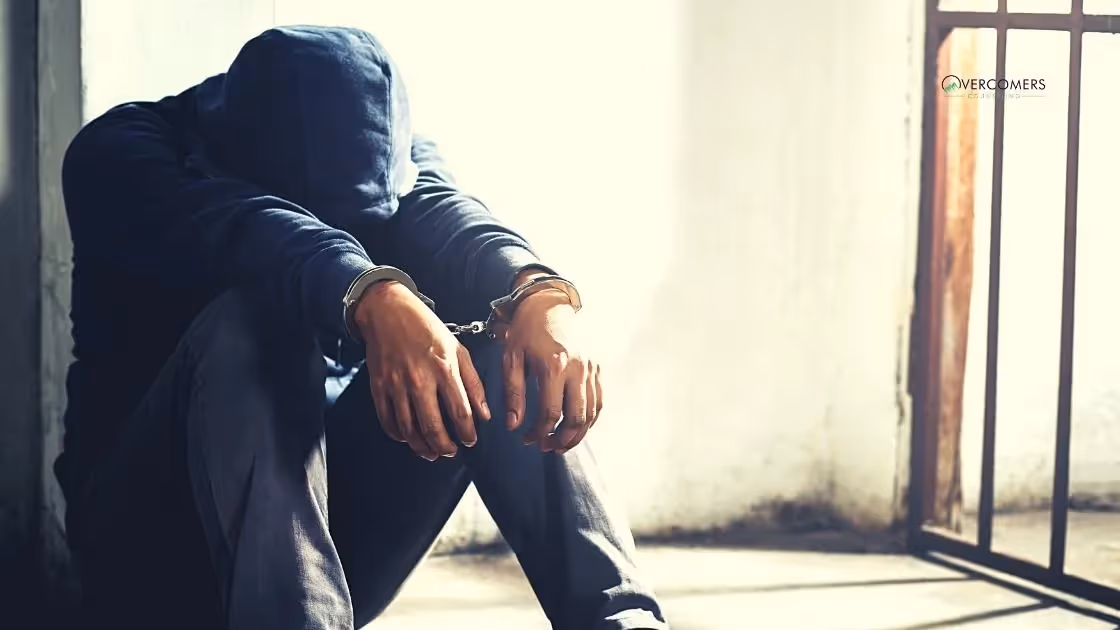 a person who is in handcuffs in a prison cell