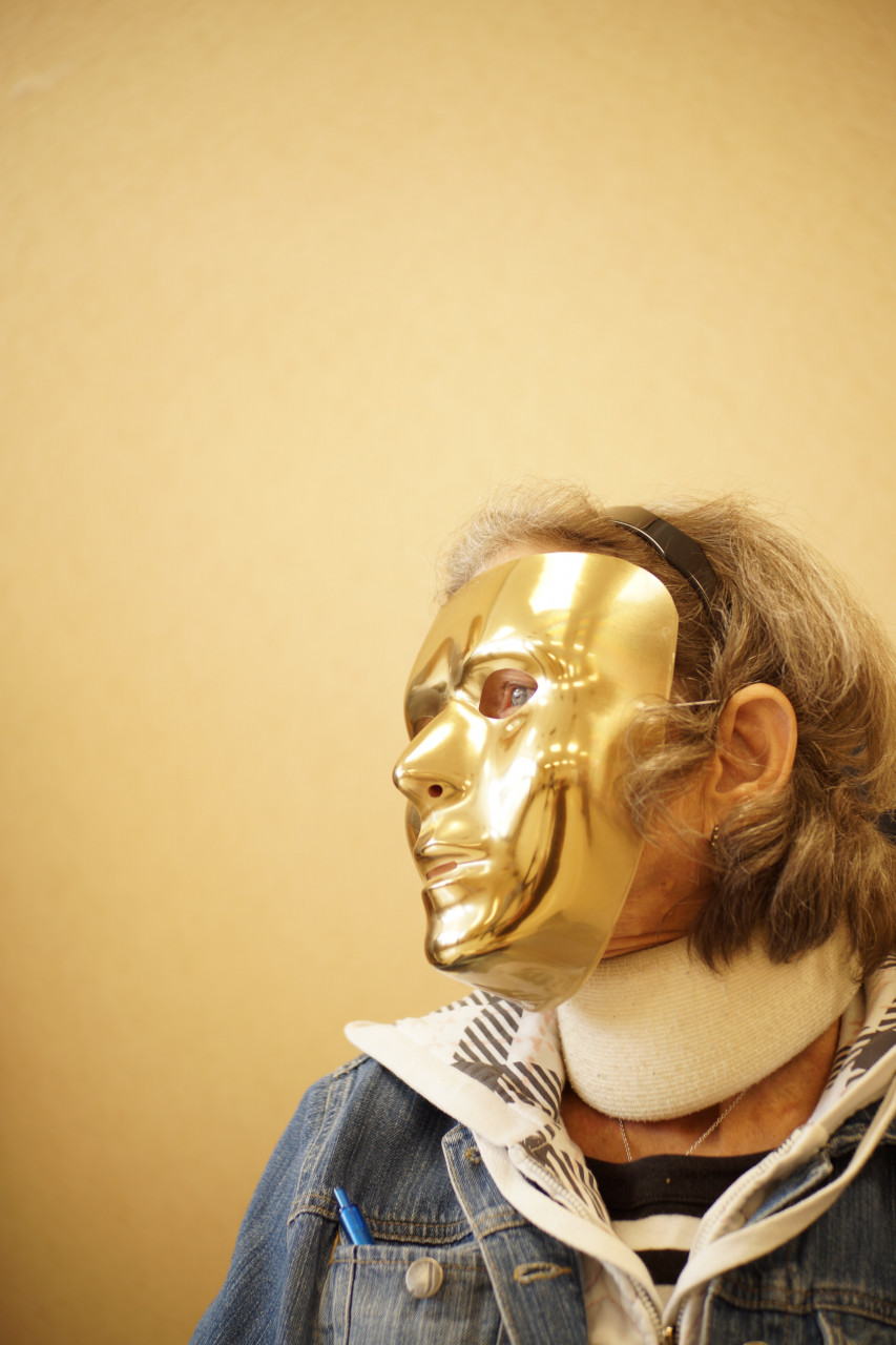 Person wearing a gold colored mask