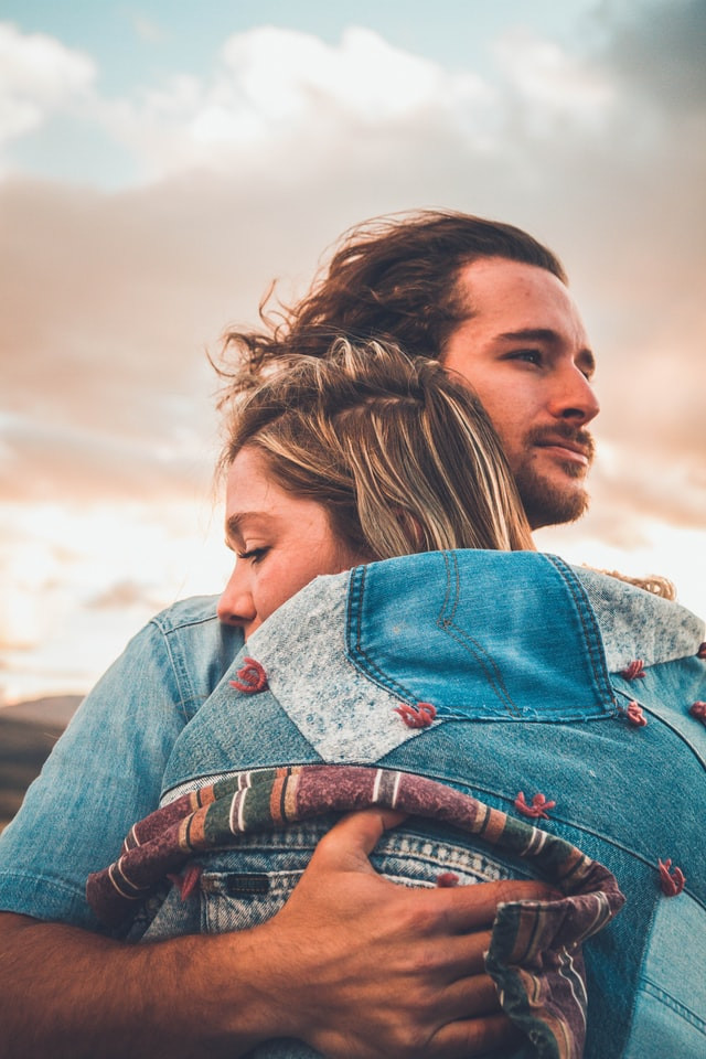 a man and woman embracing in a hug