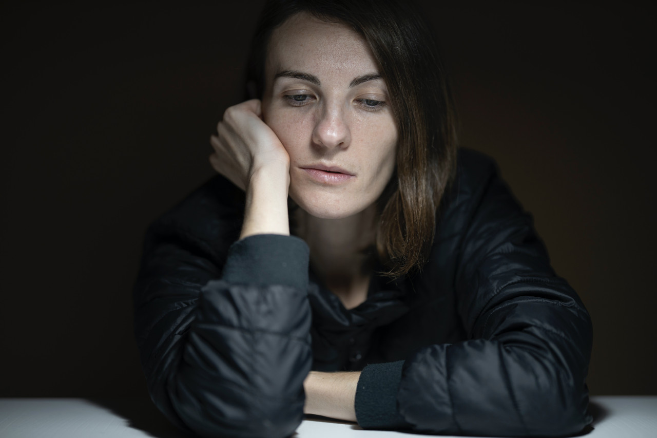 A female sitting with elbow on a surface