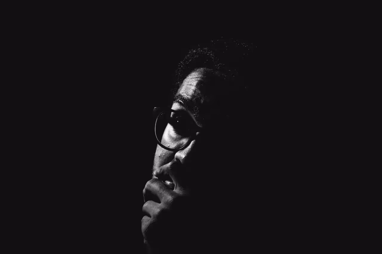 a guy with his hand across his chin