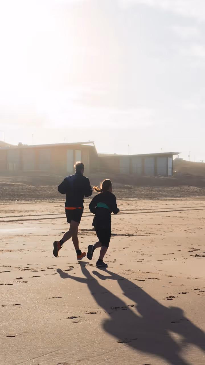 2 people going for a run on the beach