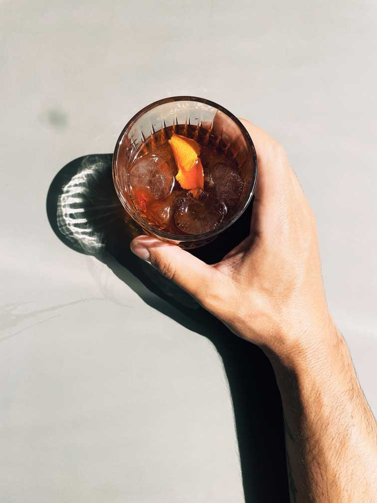 a hand holding a drink