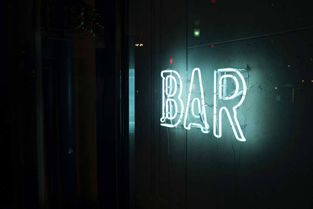 a neon sign that says bar