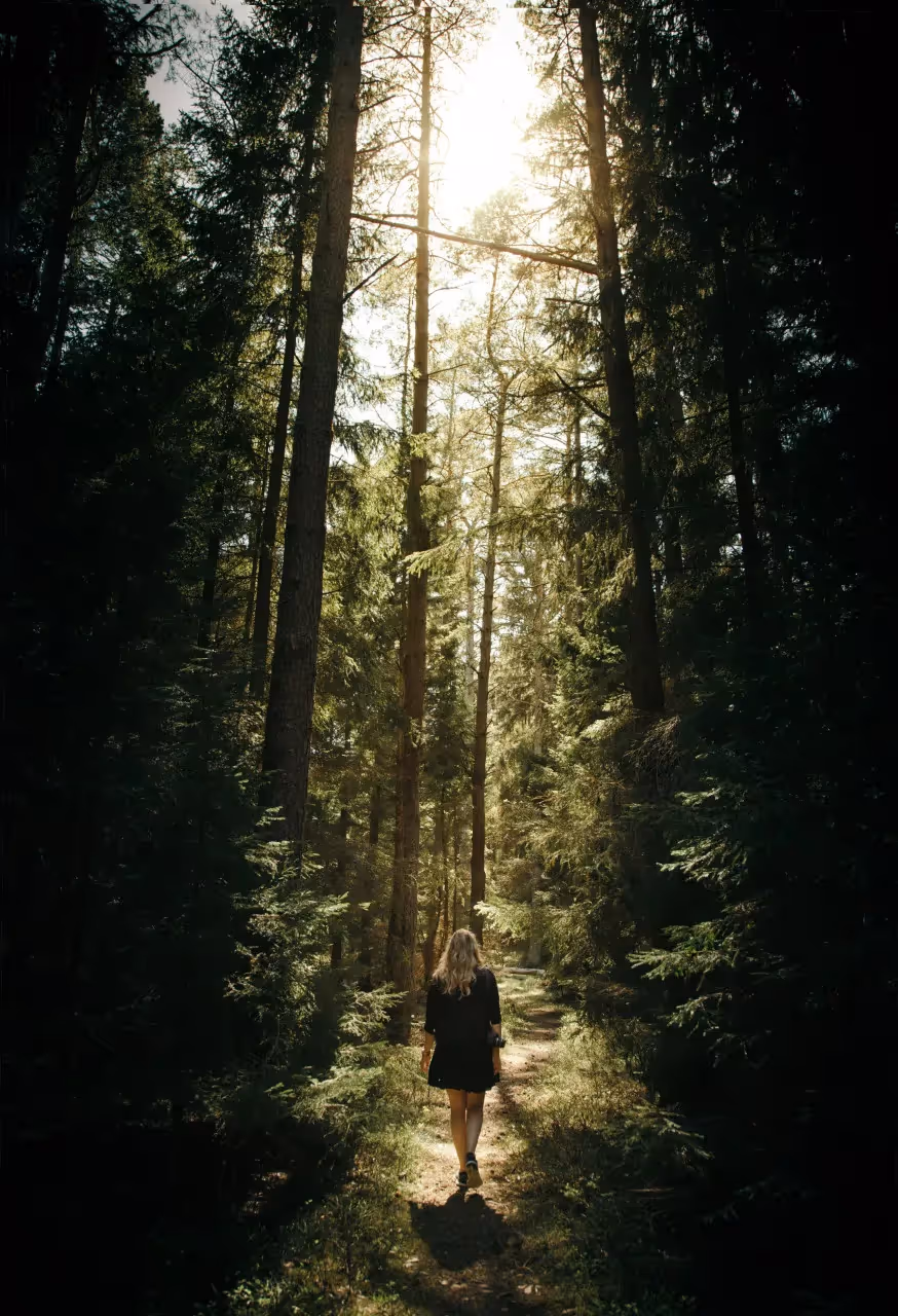 Woman walking on a path in the forest
