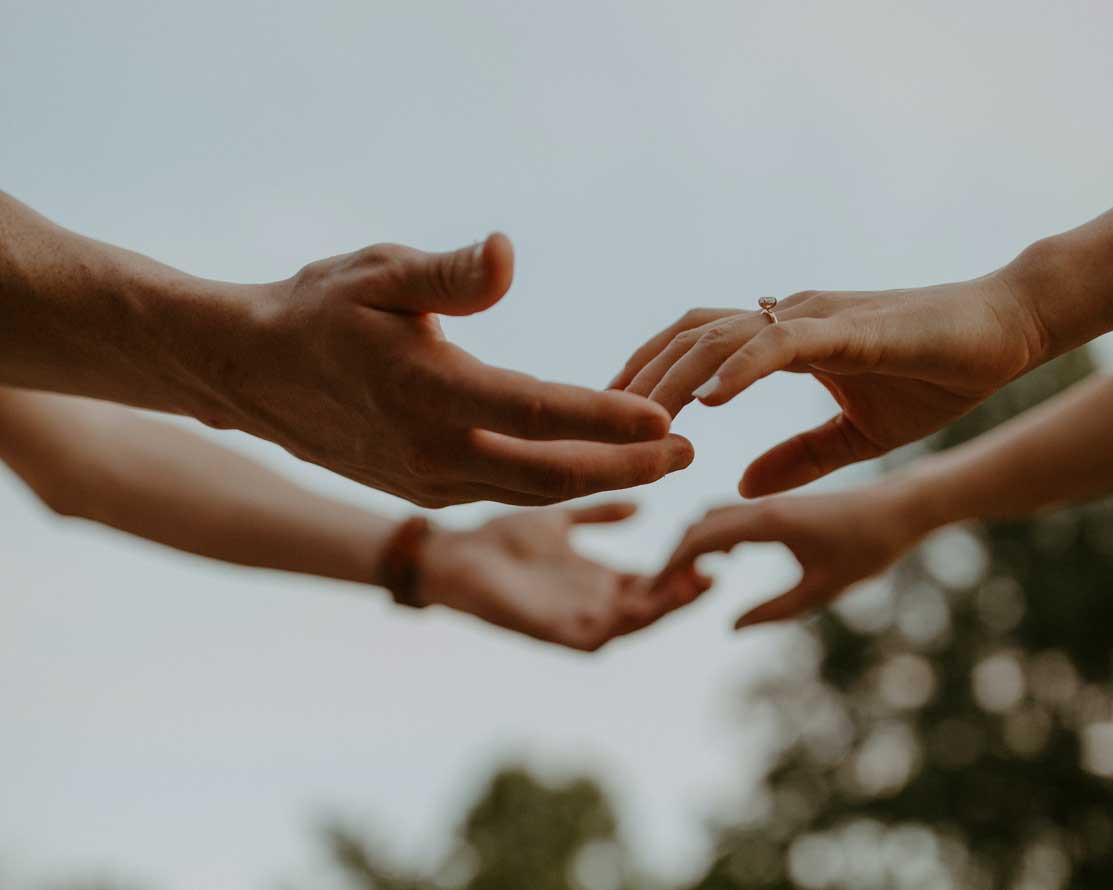 people's hands reaching out to each other