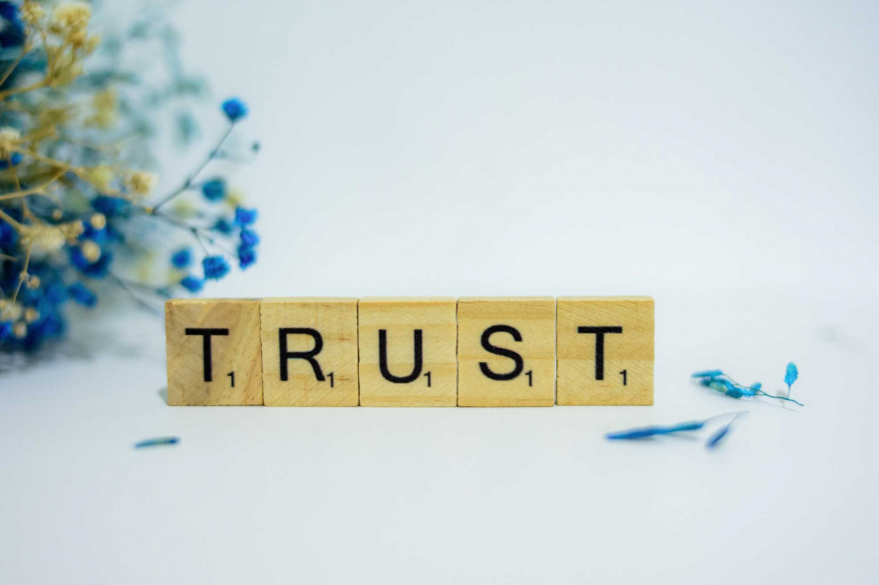 scrabble tiles with trust written on them