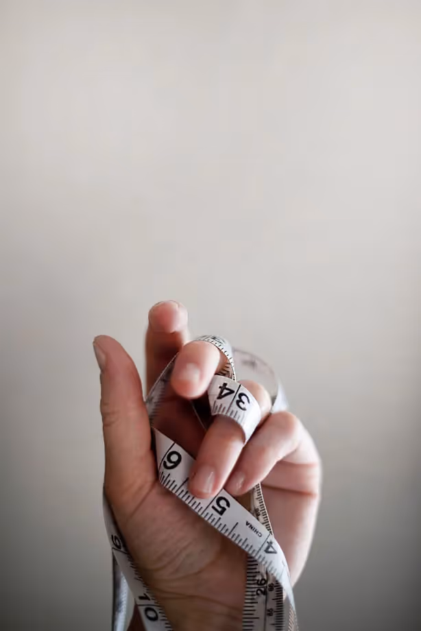 a hand holding measuring tape