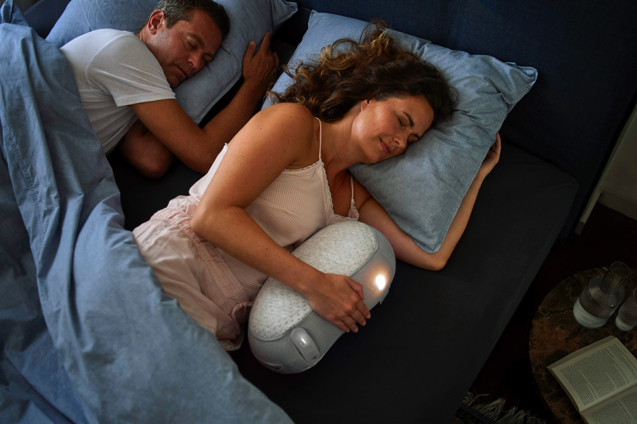 a couple sleeping next to each other in bed
