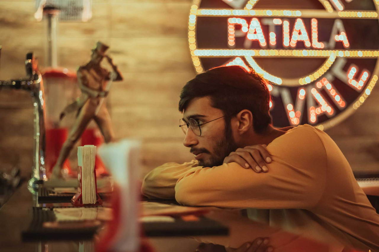 a man looking sad sitting at a table
