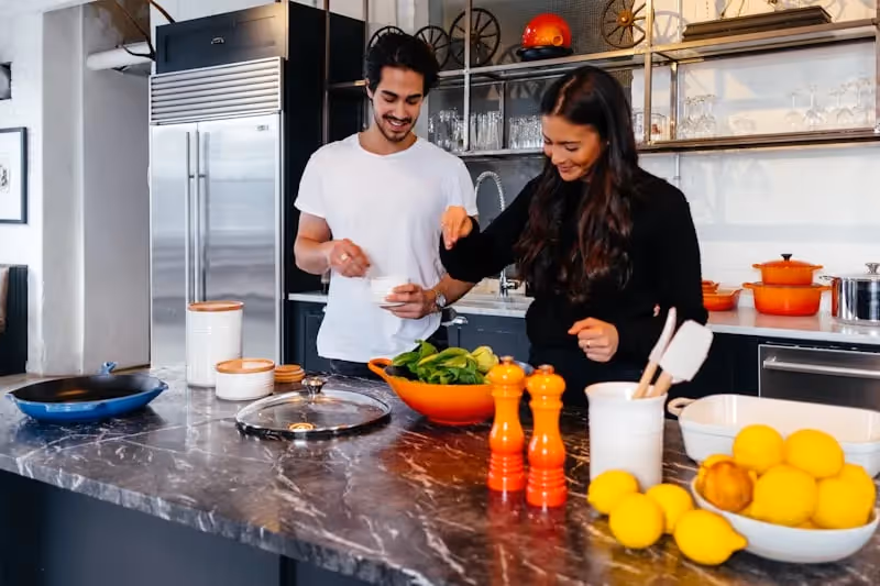 a young couple together in a kitchen