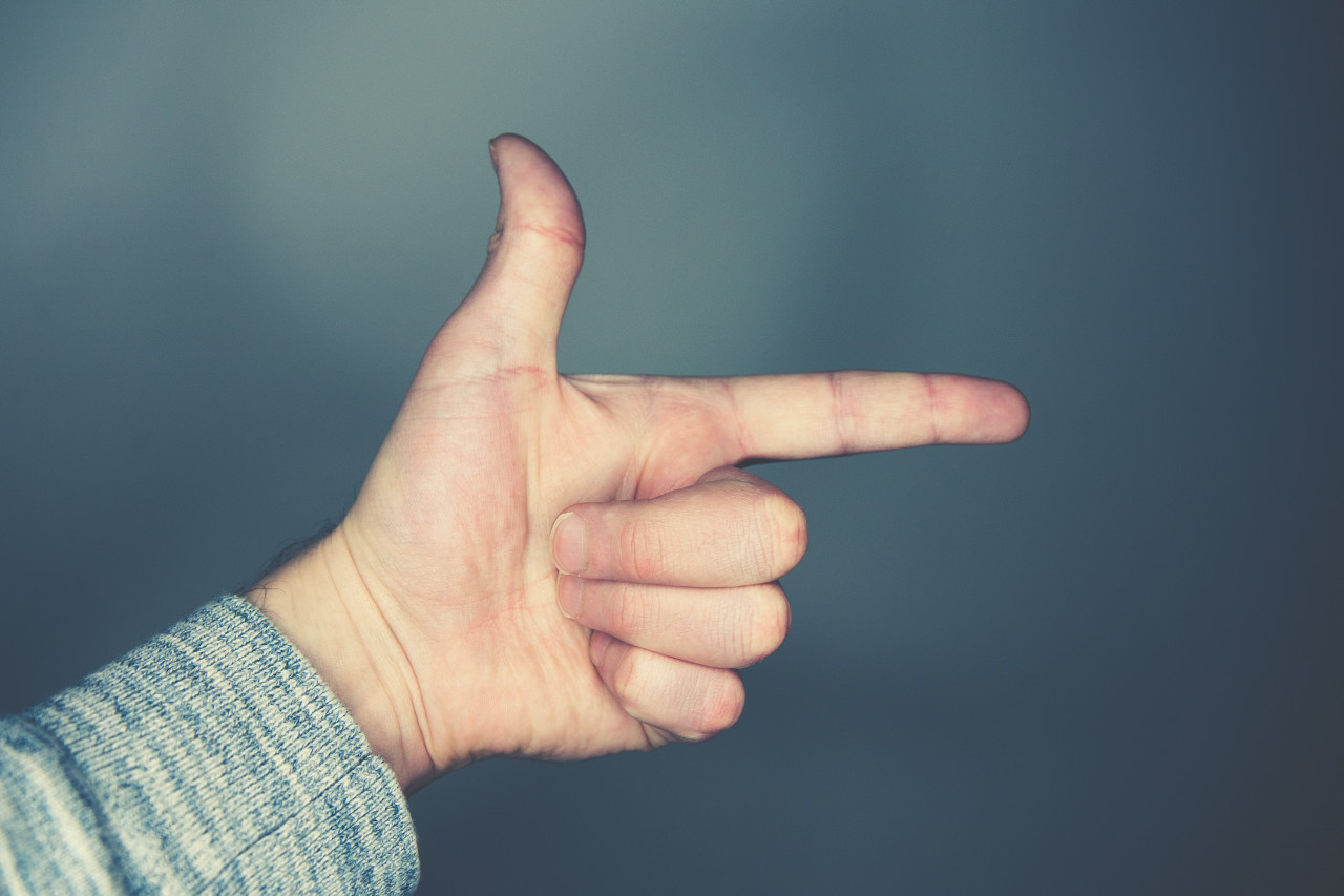 Someone pointing fingers at another.