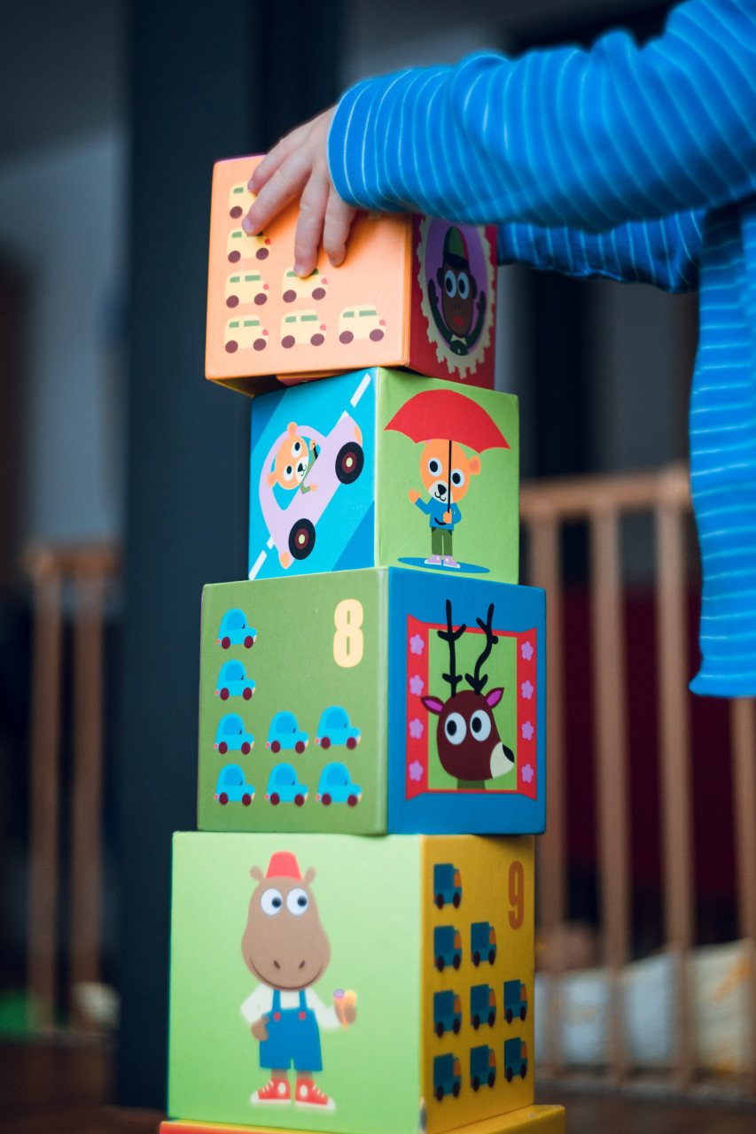 A child focused on building something out of his bricks.