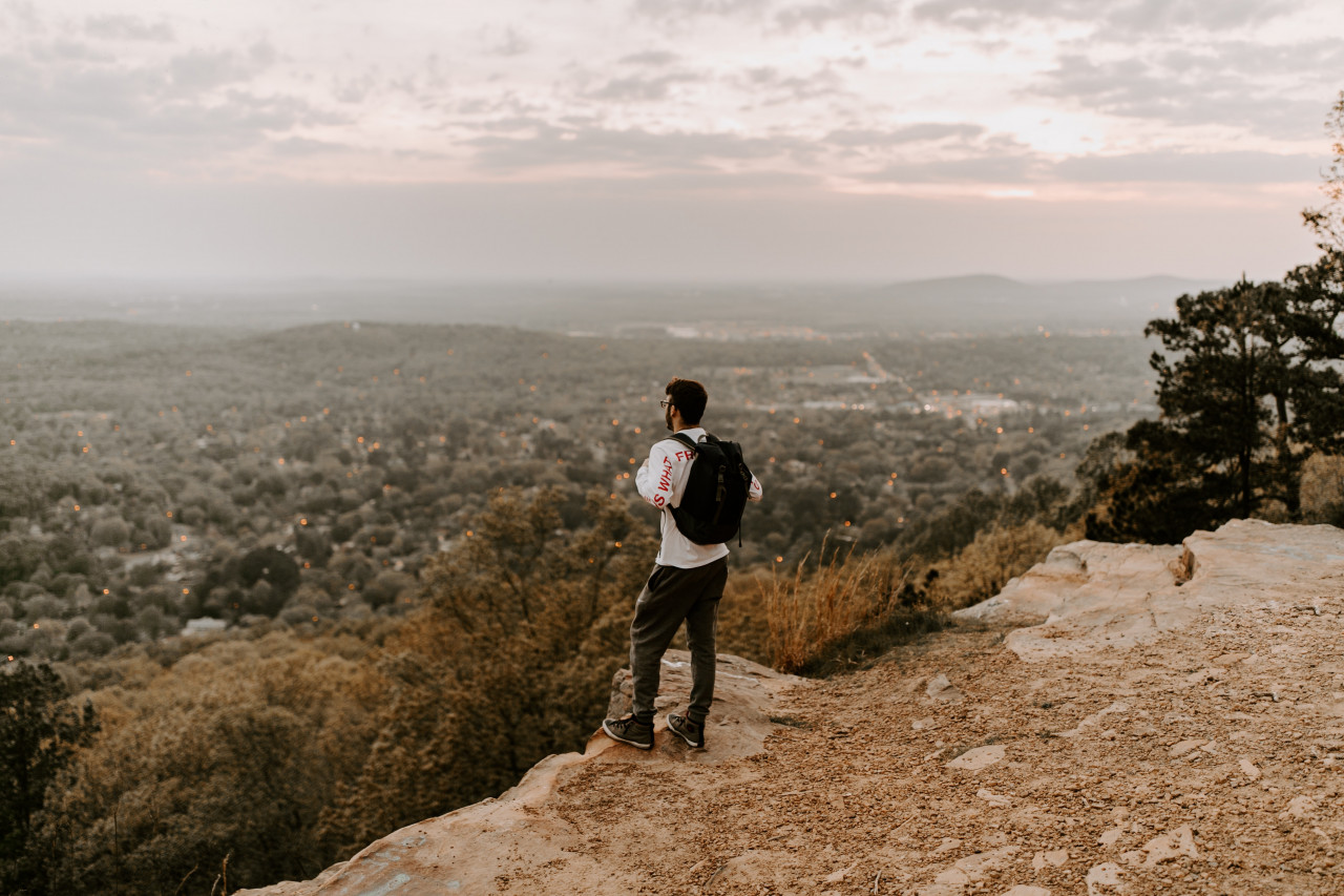 A lone man standing on a hill.