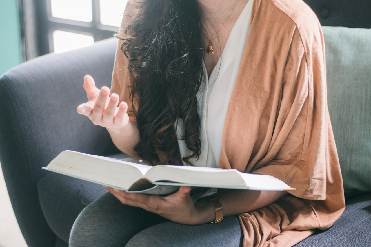 A therapist holding a book.