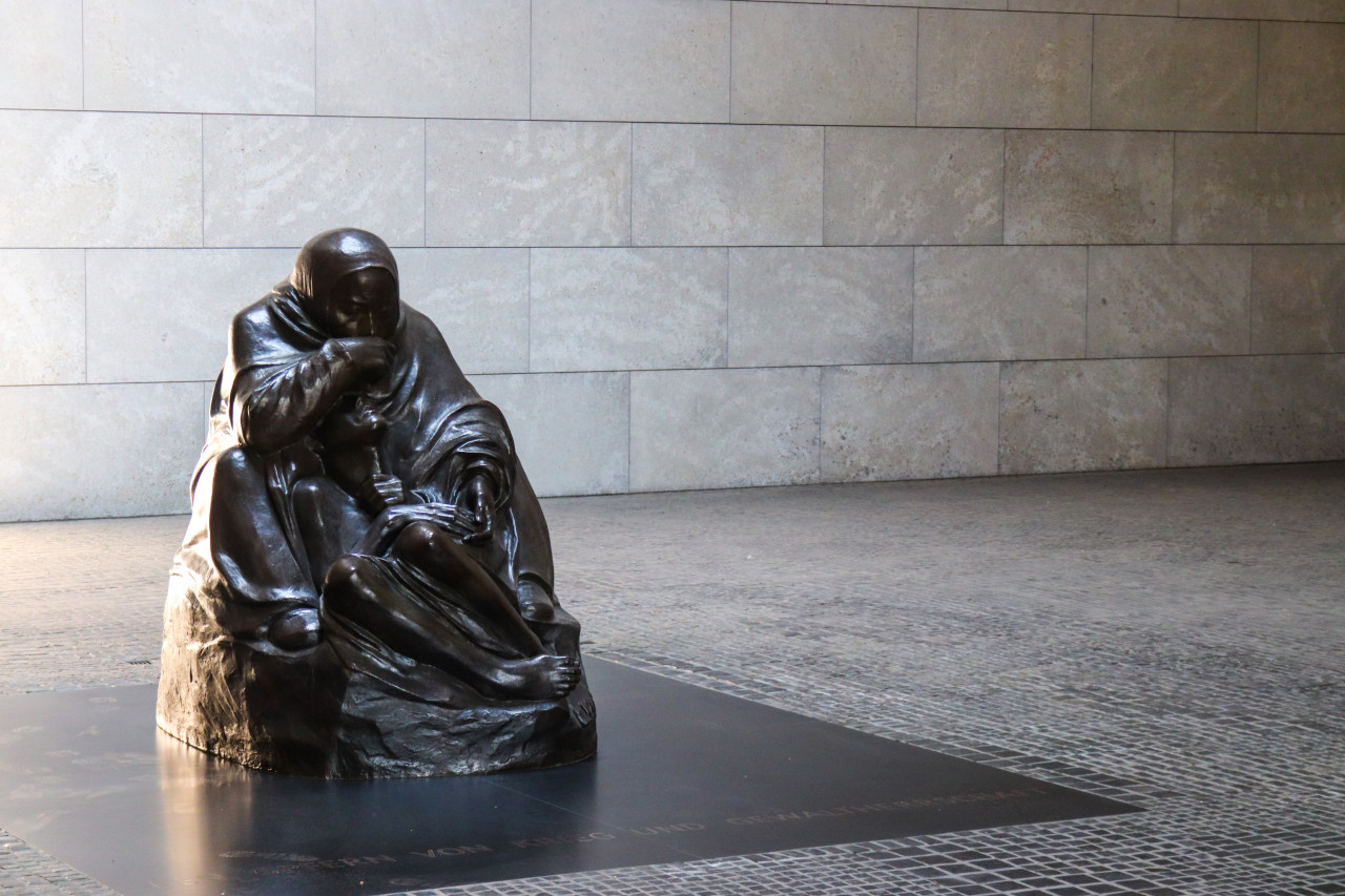 A statue in a grieving pose.
