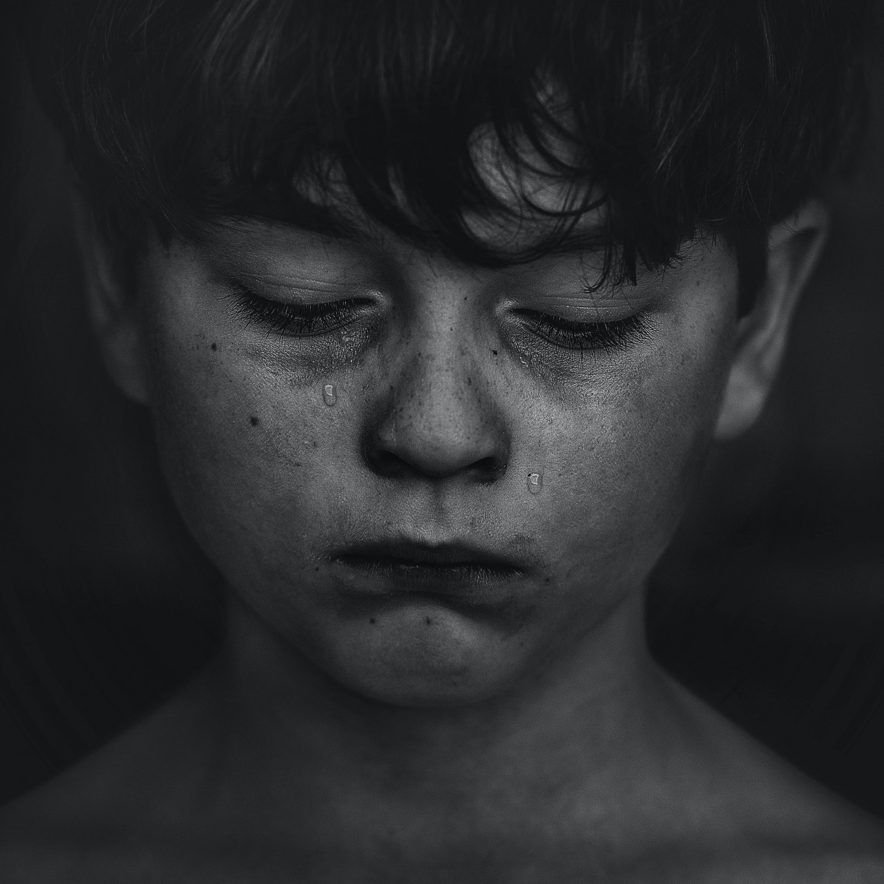 A victim of bullying crying.