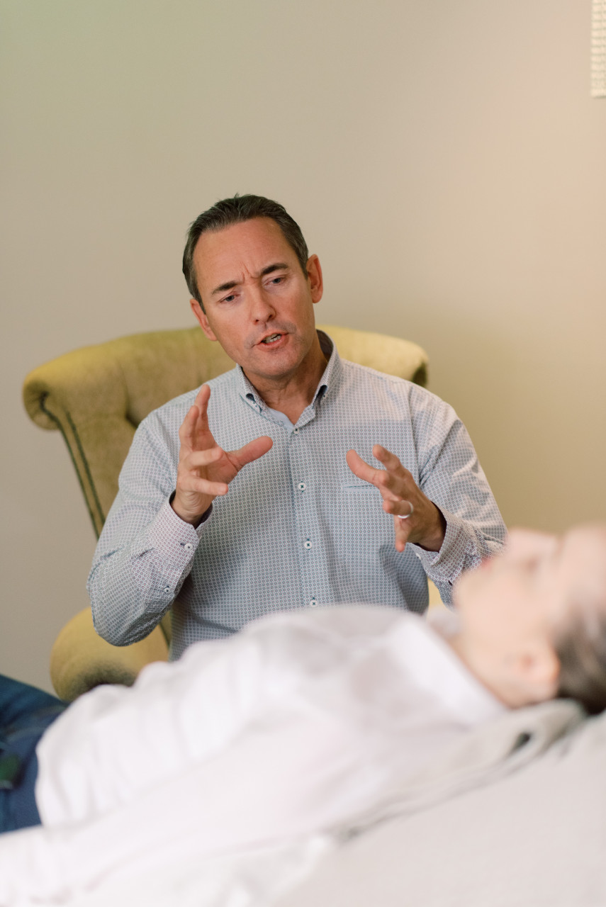 A therapist talking to his patient.