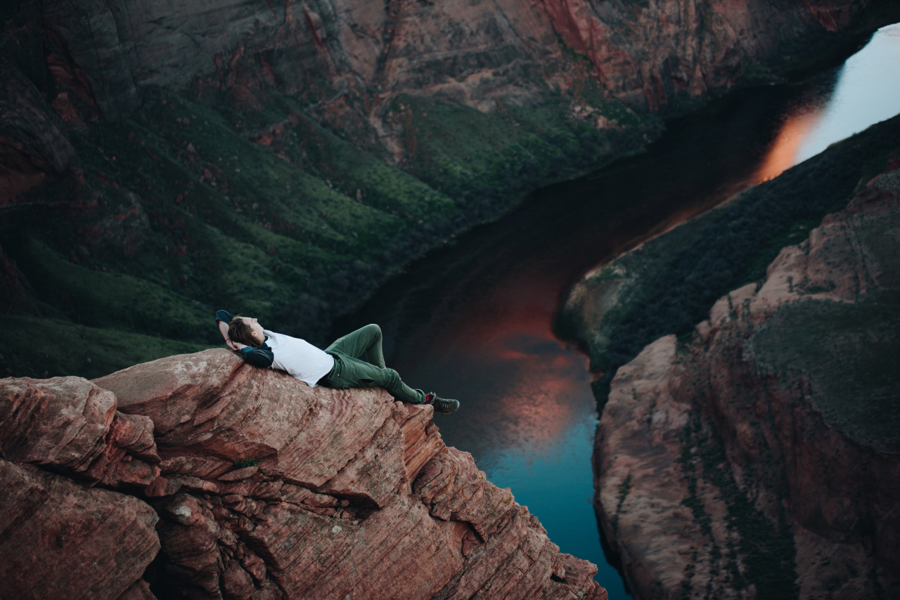 A man resting on a rock.