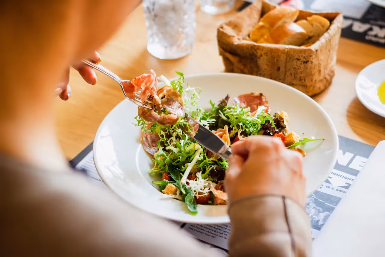 A person eating a salad