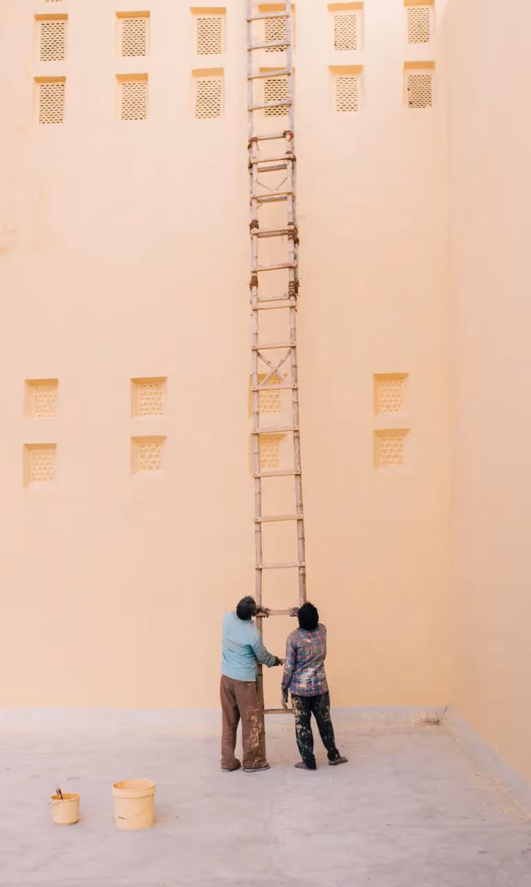 Two engineers looking up the ladder.