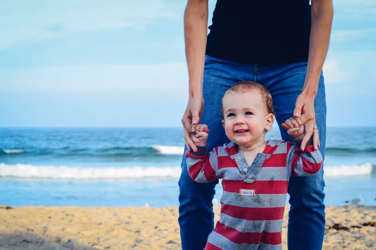 A father with his son on a low-cost beach.