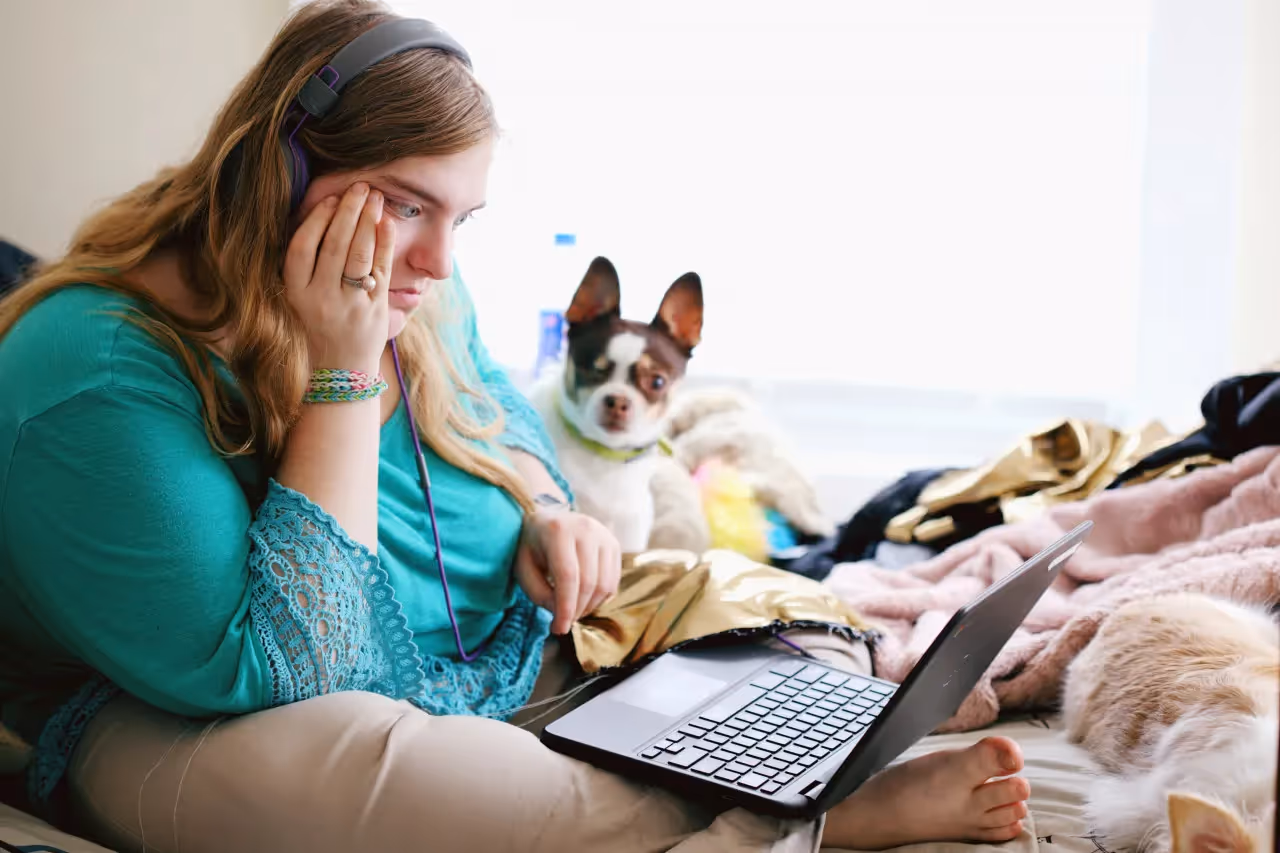 A woman concentrating on her laptop screen