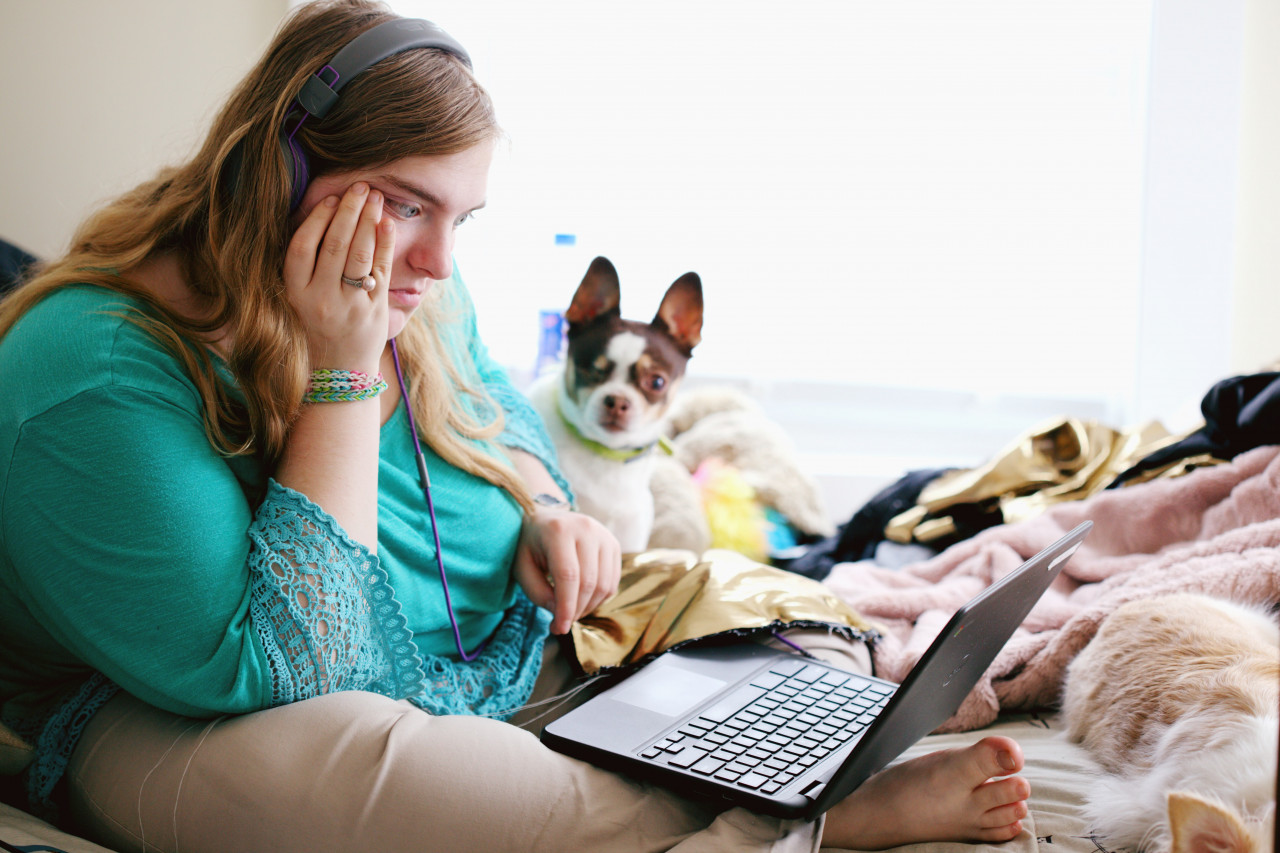 A woman concentrating on her laptop screen