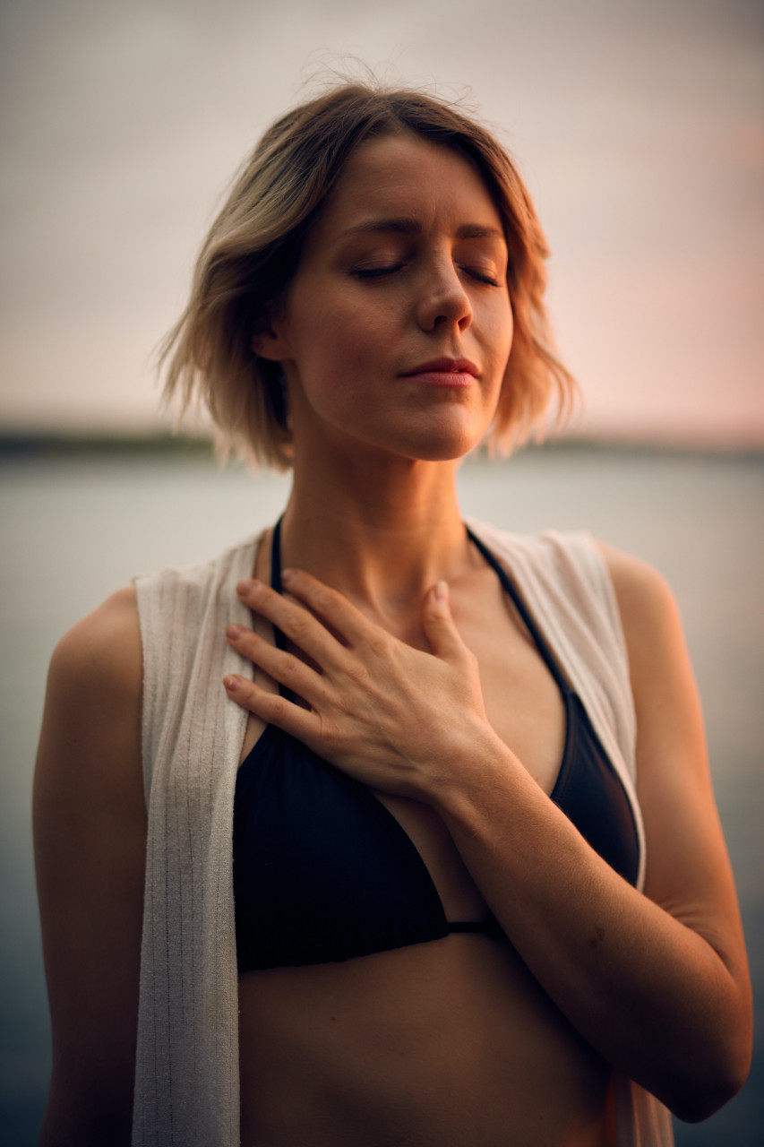A woman engaging in relaxing breathing techniques.