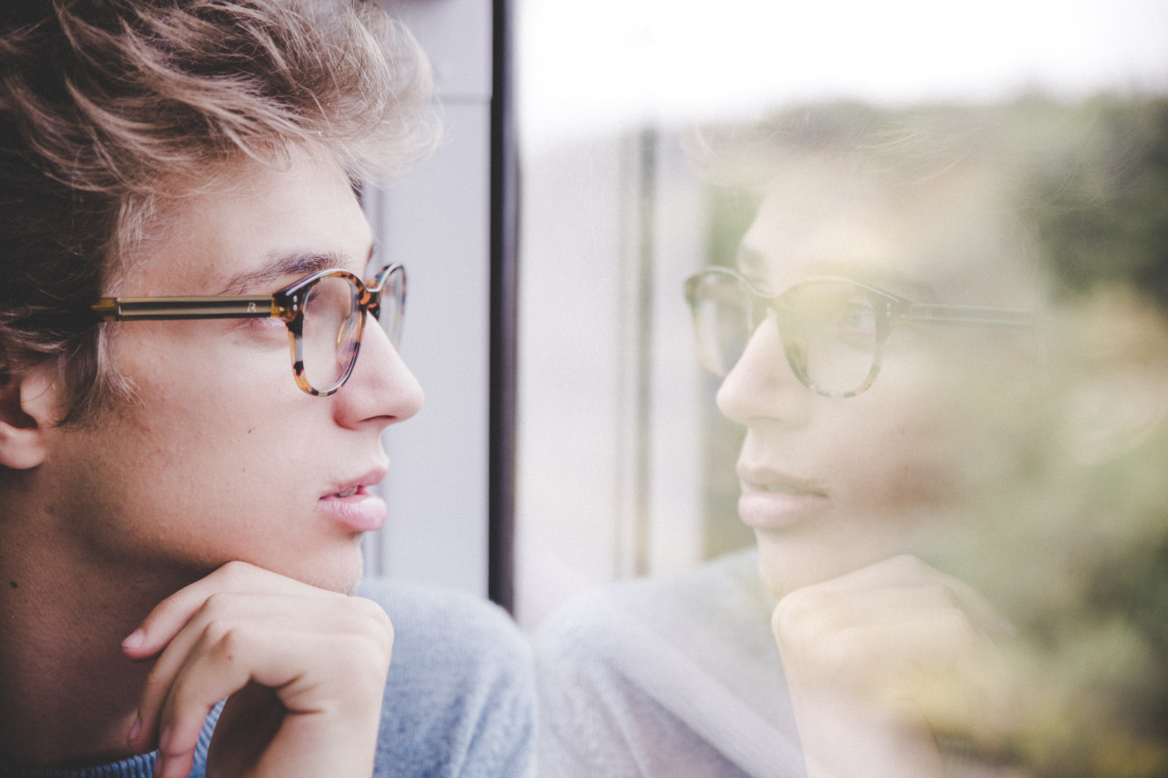 A person looking out a window.