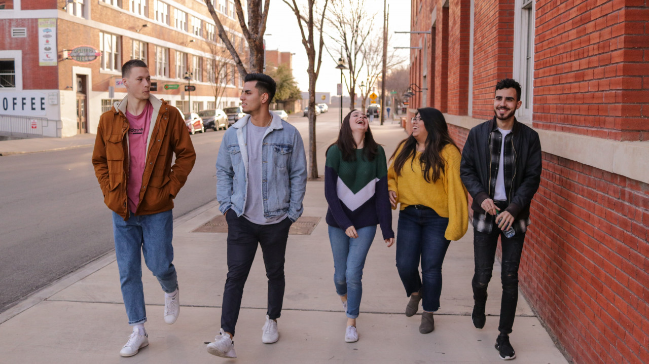 A group of teens walking down the street.