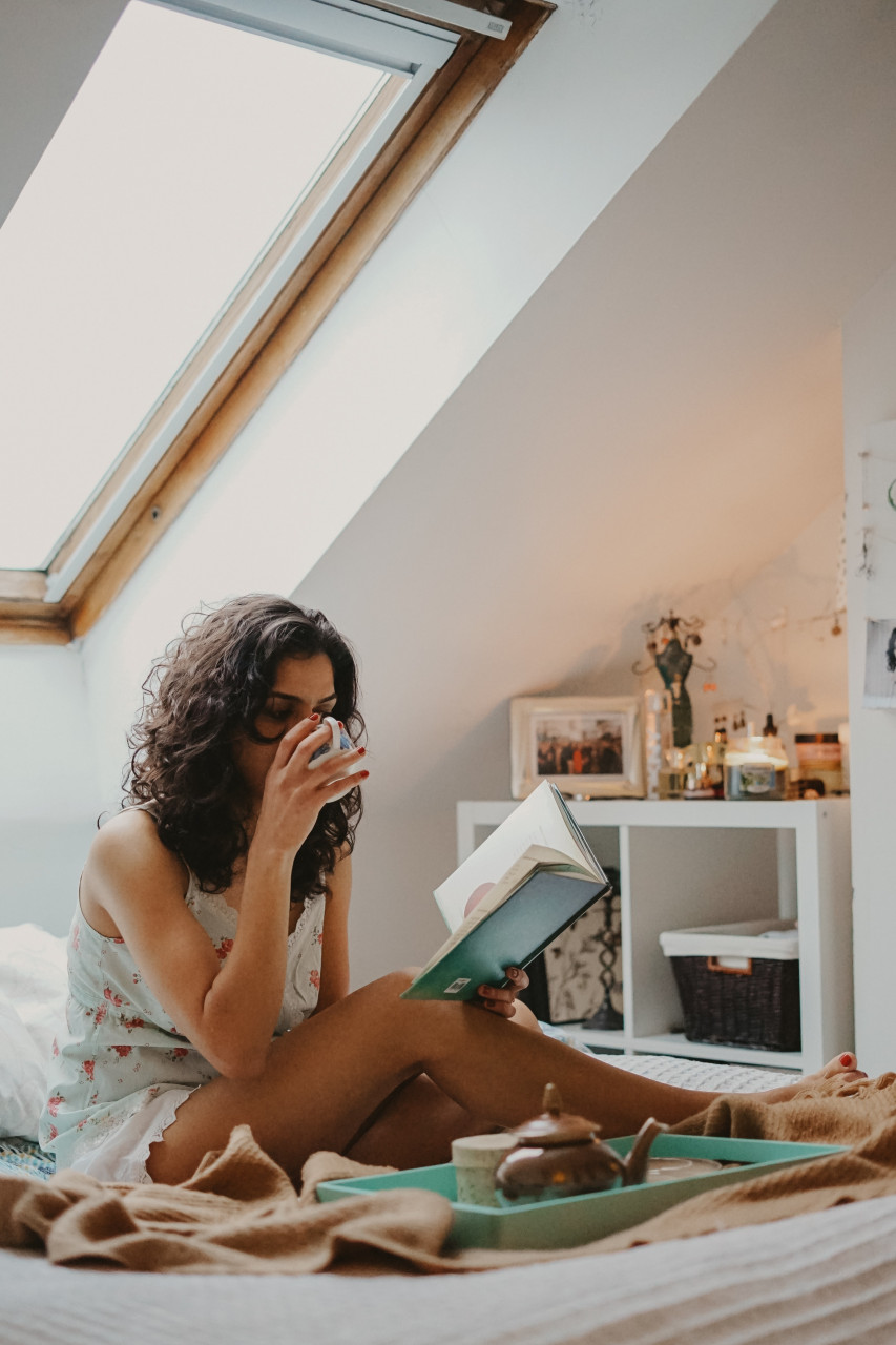 A lady relaxing and reading.