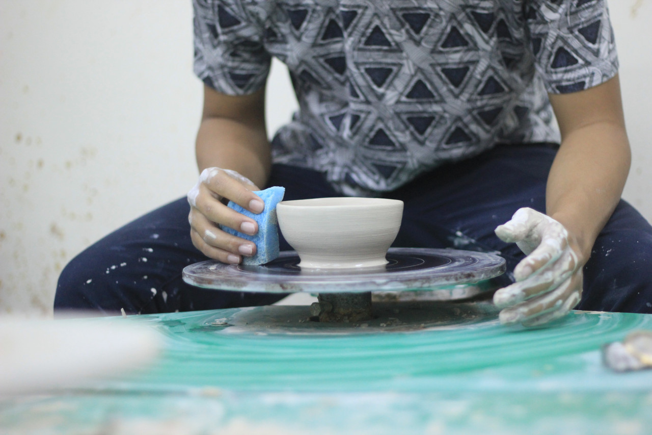 A man creating art in sculpting.