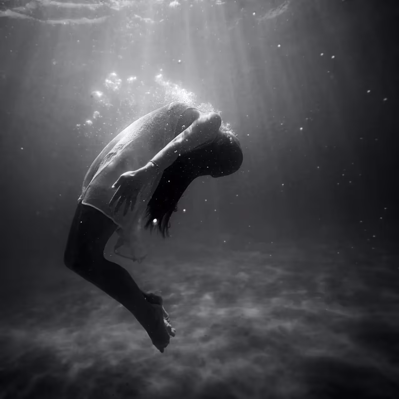 a woman floating under water