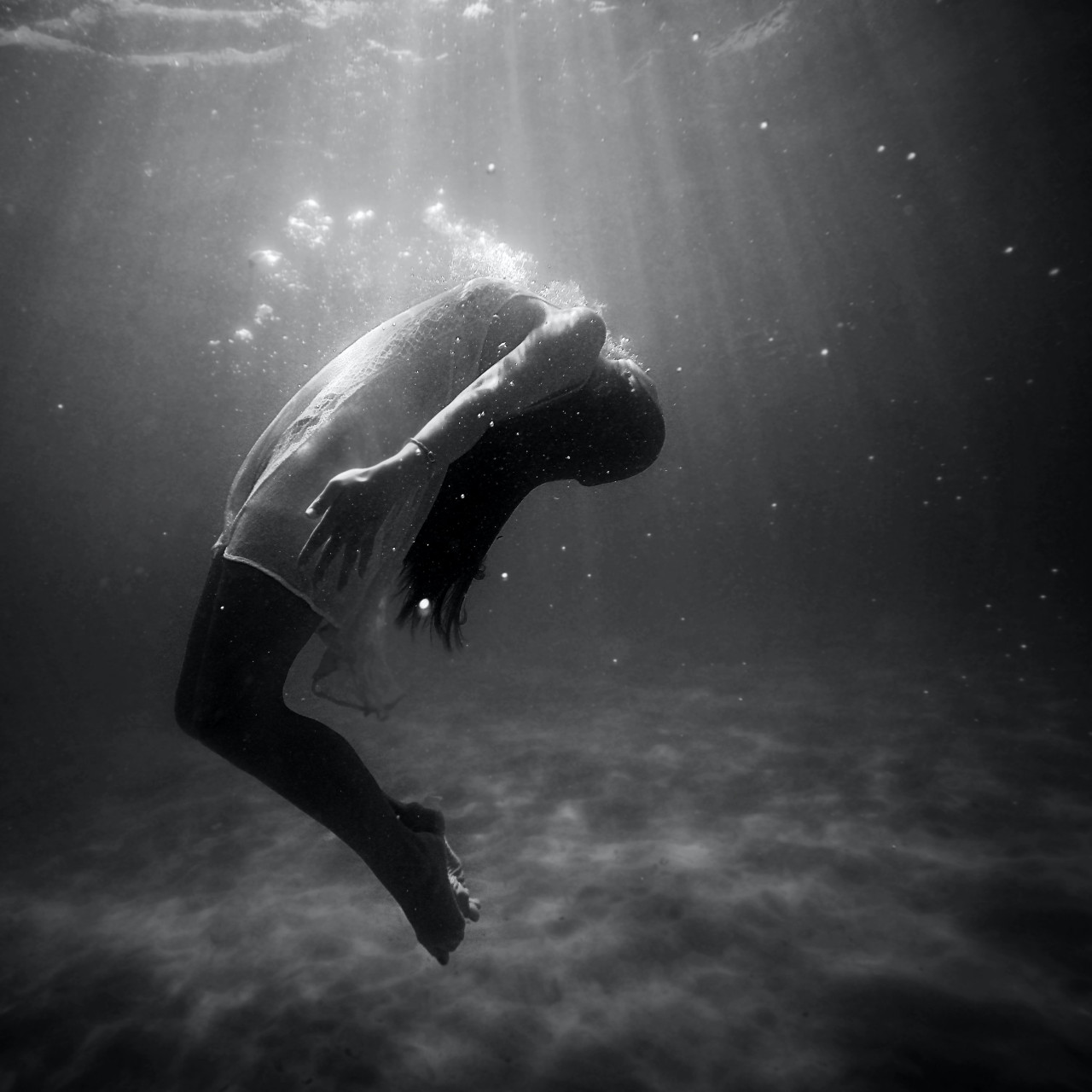 a woman floating under water
