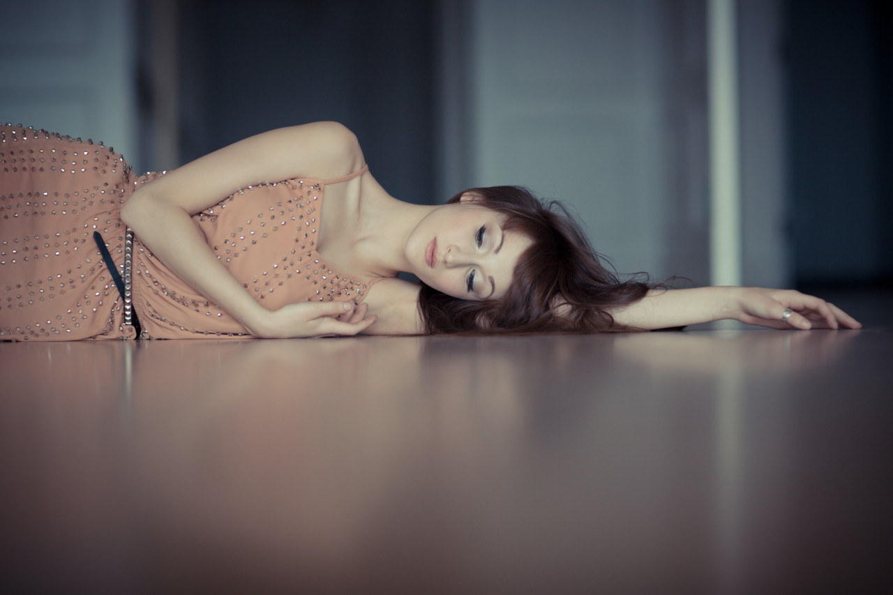 a woman laying on her side on the floor