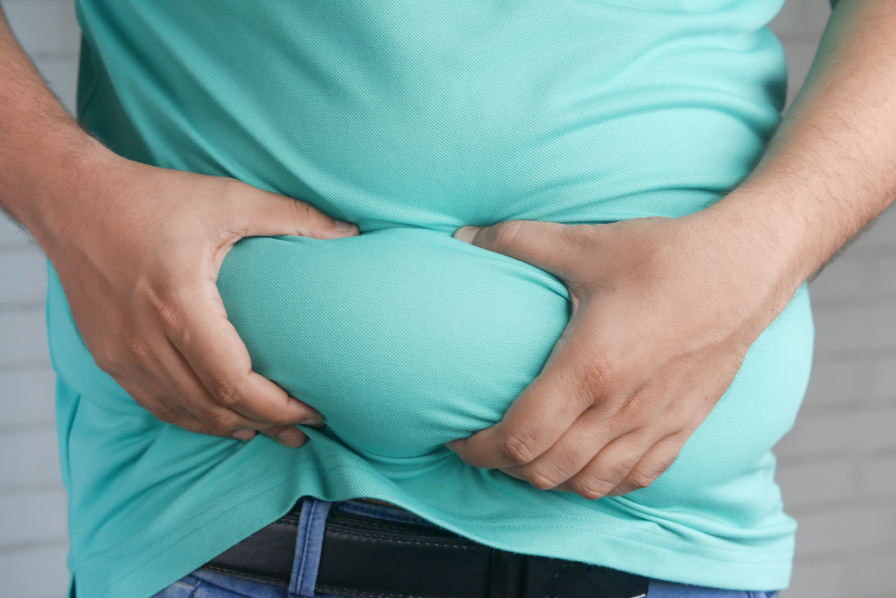 A man holding his stomach in pain.