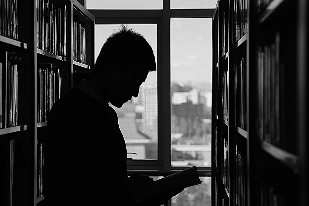 A man learning from a book.