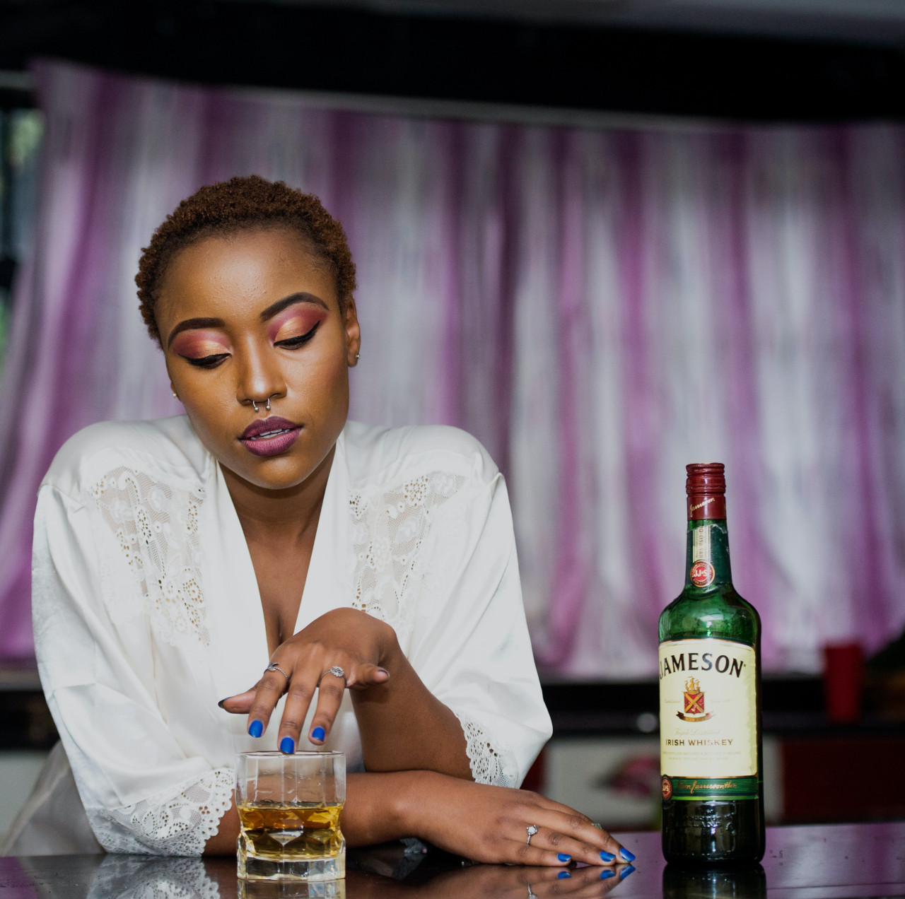 A lady drinking alcohol.