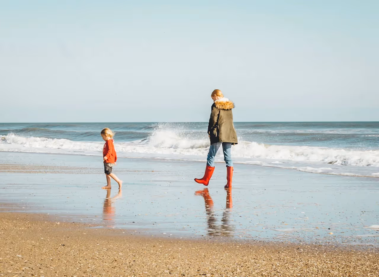 A mother spending and child walking on the beach