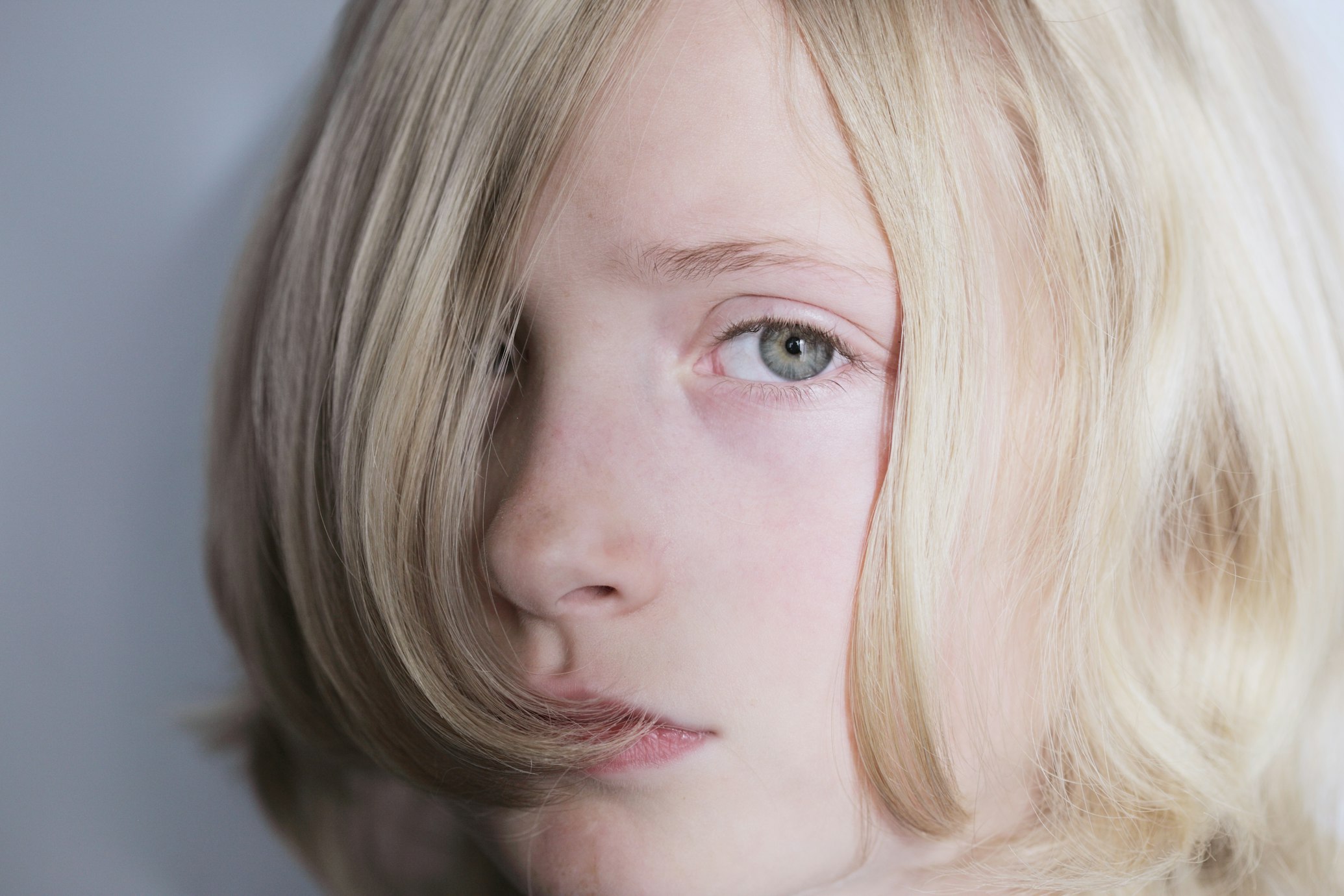 Blonde haired child looking sad