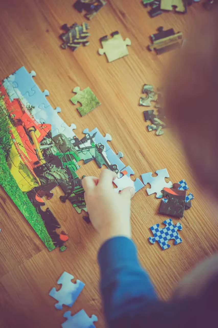 A child completing a complex puzzle.