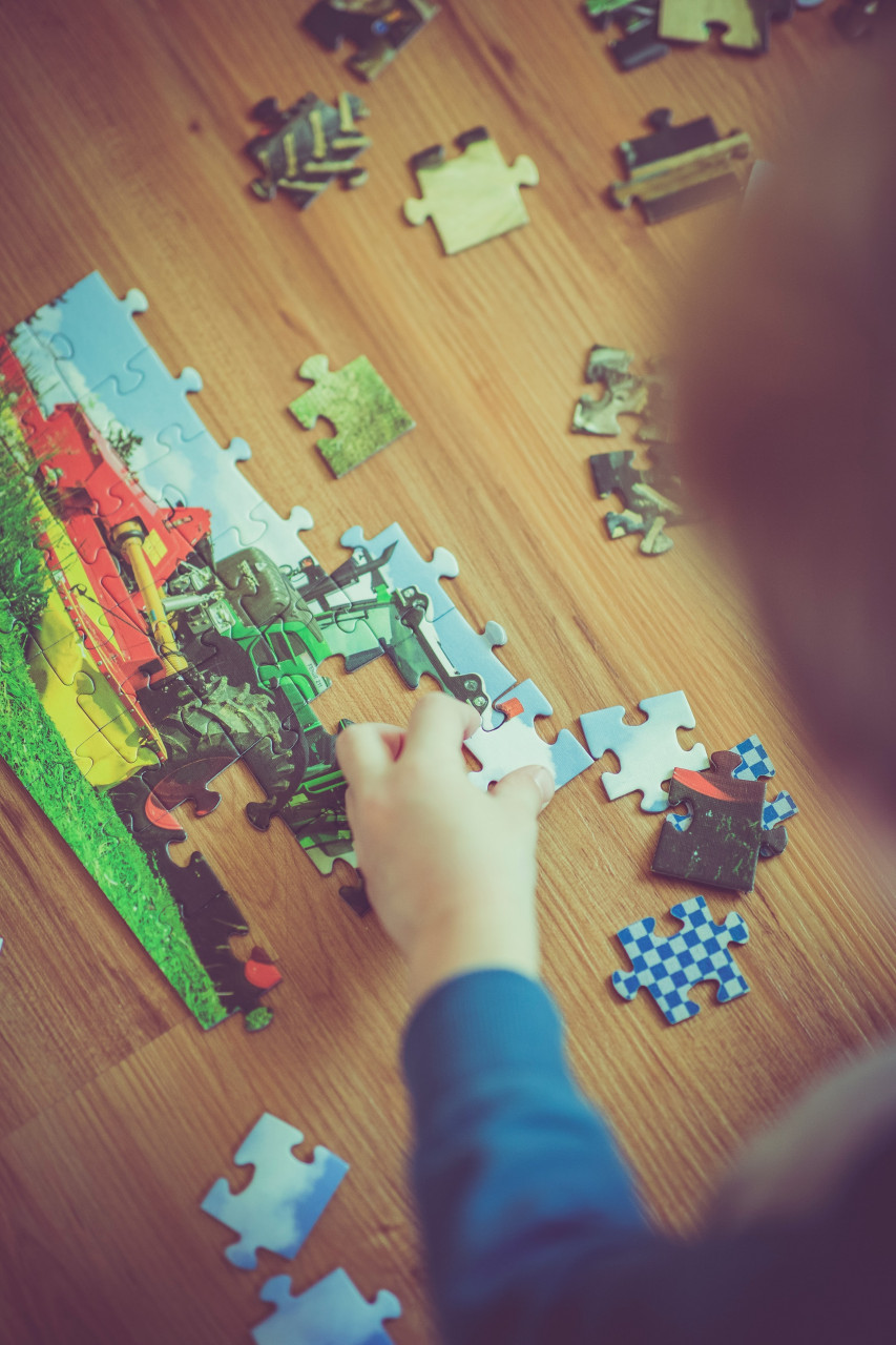 A child completing a complex puzzle.